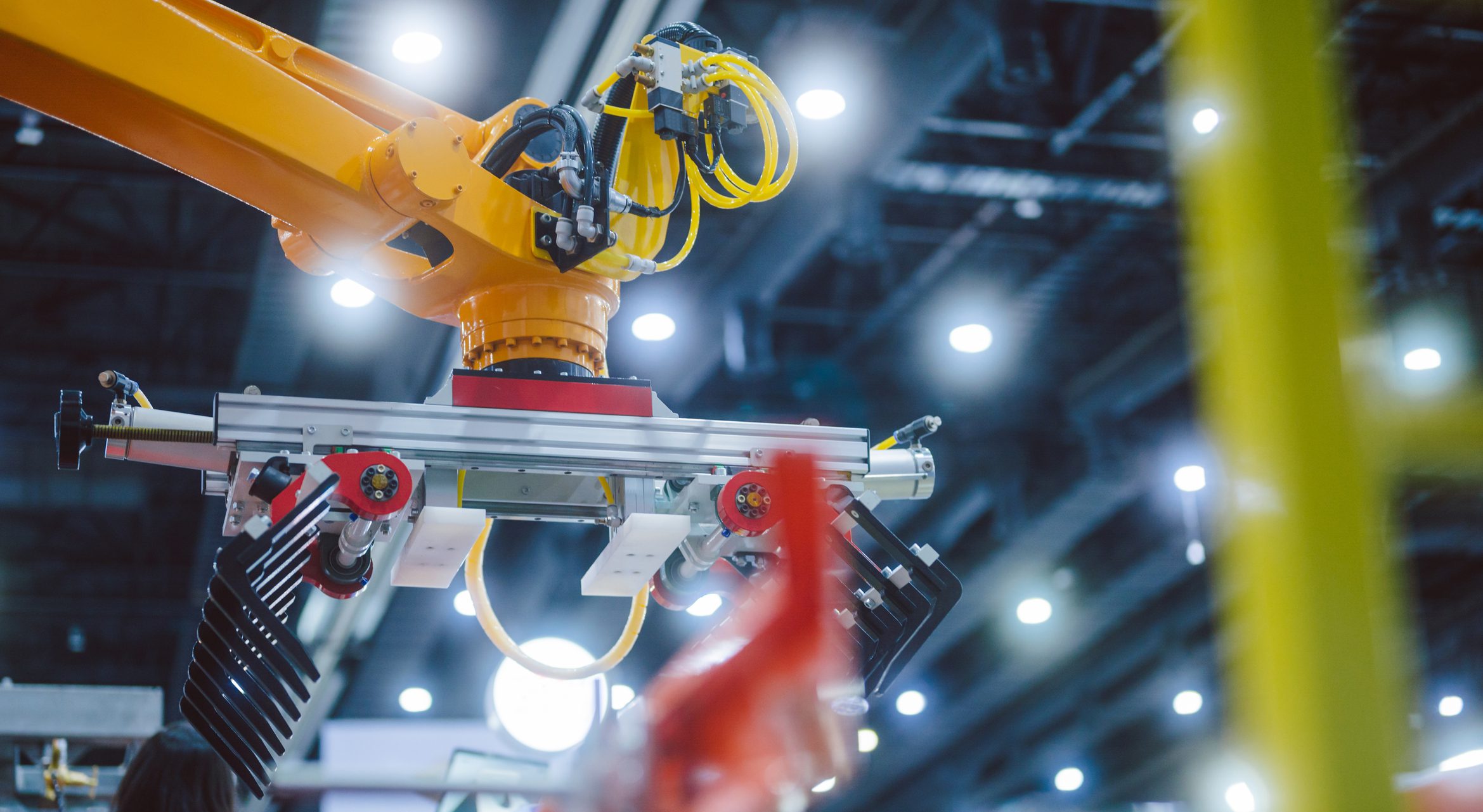 industrial robotic arm transporting large products in automated warehouse and logistics facility. concept of smart warehouse system, industrial automation, robotic handling technology, supply chain innovation, ai logistics, automated material transport